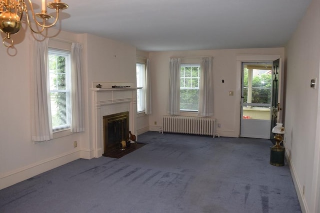 959 Ray St, Fall River, MA 02720 - unfurnished living room with radiator heating unit, dark colored carpet, a chandelier, and a fireplace with flush hearth