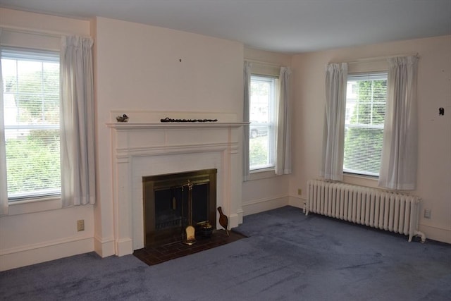 959 Ray St, Fall River, MA 02720 - unfurnished living room featuring radiator heating unit, dark carpet, and plenty of natural light