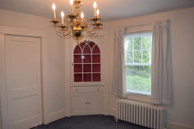 959 Ray St, Fall River, MA 02720 - unfurnished dining area featuring radiator, a chandelier, and dark carpet