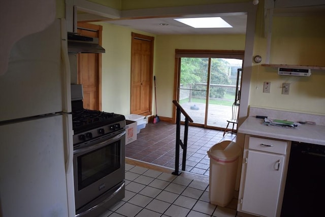 959 Ray St, Fall River, MA 02720 - kitchen featuring freestanding refrigerator, stainless steel range with gas stovetop, under cabinet range hood, black dishwasher, and light countertops