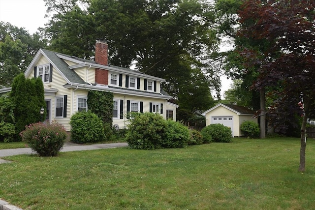 959 Ray St, Fall River, MA 02720 - view of home's exterior featuring an outdoor structure, a chimney, a lawn, and a detached garage