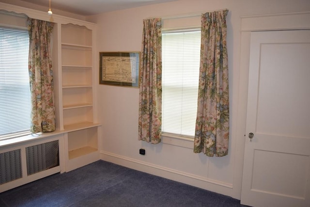 959 Ray St, Fall River, MA 02720 - empty room with radiator, dark colored carpet, and healthy amount of natural light