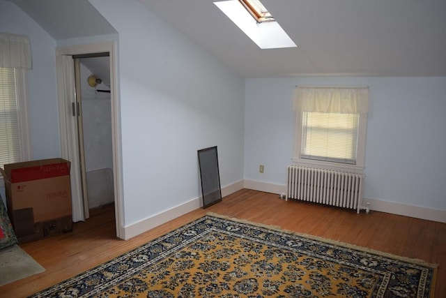 959 Ray St, Fall River, MA 02720 - additional living space featuring radiator heating unit, a skylight, wood finished floors, and vaulted ceiling