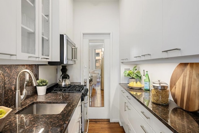 kitchen featuring white cabinetry, sink, dark stone counters, and appliances with stainless steel finishes