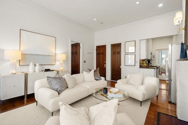 living room featuring dark hardwood / wood-style flooring and crown molding