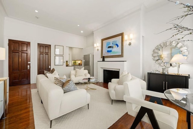 living room with wood-type flooring and ornamental molding