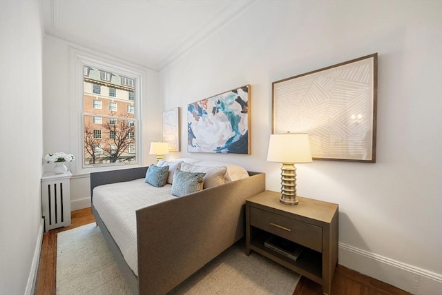 bedroom featuring light hardwood / wood-style floors and ornamental molding