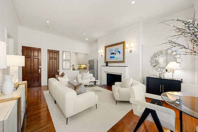 living room with hardwood / wood-style floors and ornamental molding