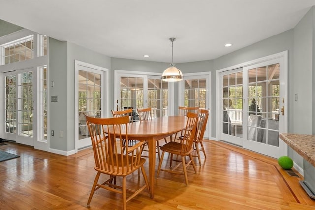 dining space with recessed lighting, baseboards, and light wood-type flooring