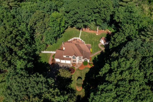 drone / aerial view with a wooded view