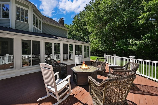 wooden terrace featuring a fire pit