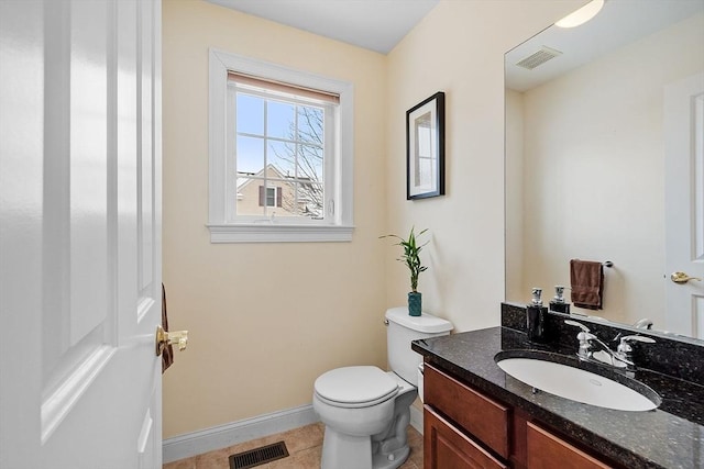 bathroom with vanity, tile patterned flooring, and toilet