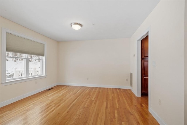 spare room with light hardwood / wood-style flooring