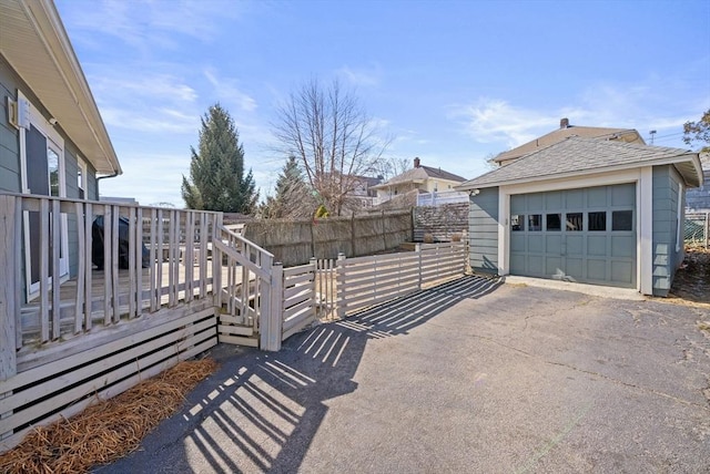 165 Harriet Ave, Quincy, MA 02171 - view of property exterior featuring an outdoor structure, asphalt driveway, and a garage