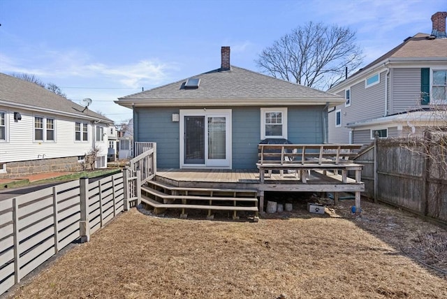 165 Harriet Ave, Quincy, MA 02171 - back of property featuring a chimney, a fenced backyard, a wooden deck, and roof with shingles