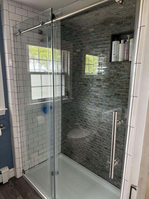 110 Atwell Cir, Marshfield, MA 02050 - bathroom featuring a shower stall, wood finished floors, and baseboard heating