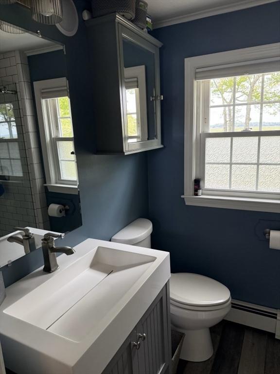 110 Atwell Cir, Marshfield, MA 02050 - bathroom with a baseboard radiator, toilet, ornamental molding, vanity, and wood finished floors