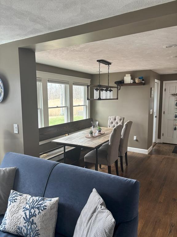 110 Atwell Cir, Marshfield, MA 02050 - dining space with a textured ceiling, wood finished floors, and baseboards