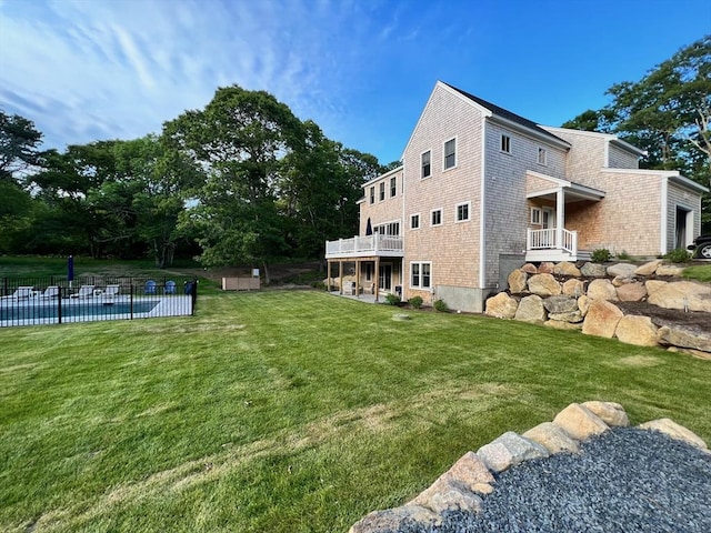 view of yard with a balcony, a swimming pool, and a patio