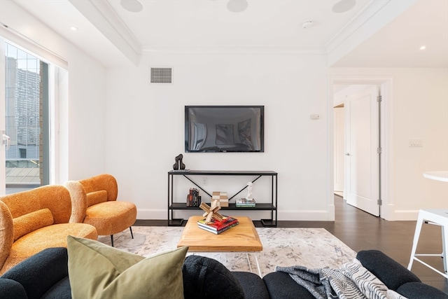 living room featuring dark hardwood / wood-style floors and ornamental molding