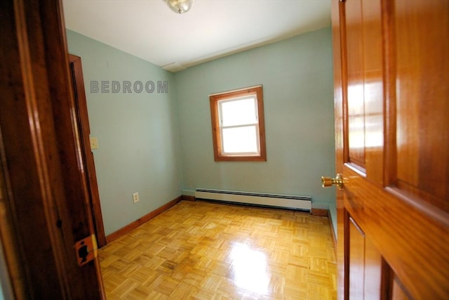 unfurnished room with baseboards and a baseboard radiator