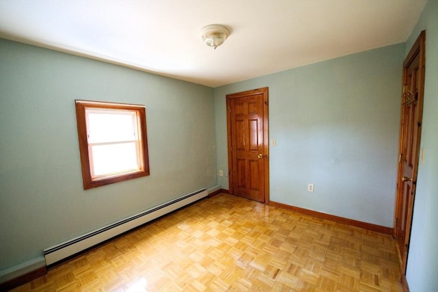 unfurnished room featuring baseboards and a baseboard radiator