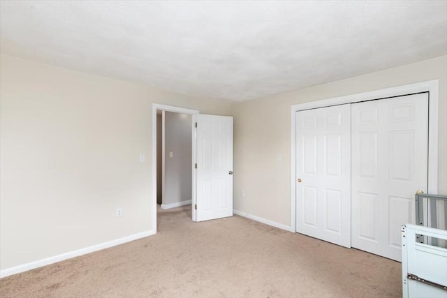 15 Crescent St Unit E, Lawrence, MA 01841 - unfurnished bedroom featuring light colored carpet, baseboards, and a closet