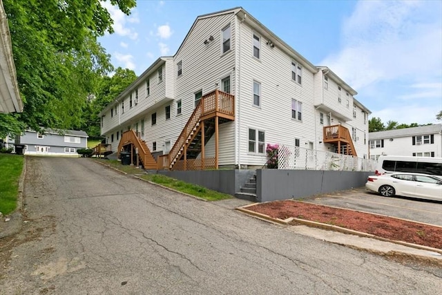 15 Crescent St Unit E, Lawrence, MA 01841 - view of building exterior featuring stairs and uncovered parking
