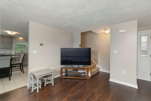 15 Crescent St Unit E, Lawrence, MA 01841 - living area with baseboards, wood finished floors, a textured ceiling, and stairs