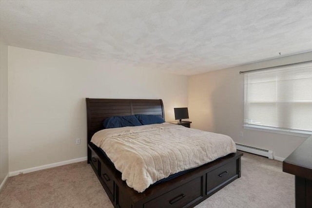 15 Crescent St Unit E, Lawrence, MA 01841 - bedroom featuring a baseboard radiator, light colored carpet, and baseboards