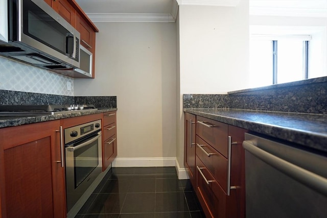15 N Beacon St Unit 1006, Boston, MA 02134 - kitchen featuring stainless steel appliances, decorative backsplash, crown molding, dark tile patterned flooring, and baseboards