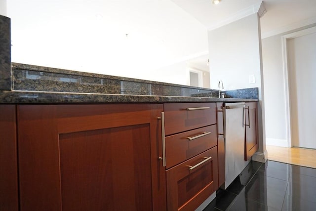 15 N Beacon St Unit 1006, Boston, MA 02134 - kitchen with dark stone counters, brown cabinetry, and baseboards