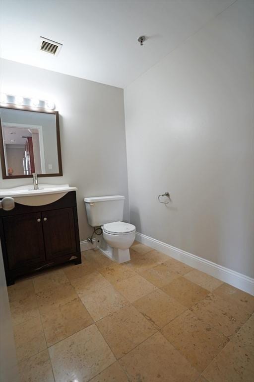 15 N Beacon St Unit 1006, Boston, MA 02134 - bathroom with baseboards, vanity, and toilet