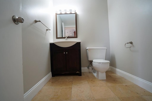 15 N Beacon St Unit 1006, Boston, MA 02134 - bathroom with toilet, vanity, baseboards, and stone tile flooring