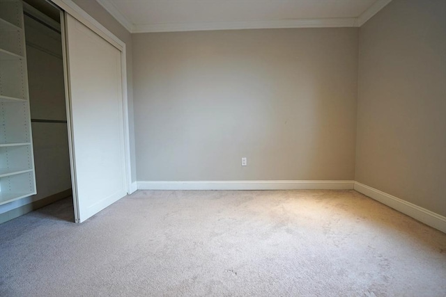 15 N Beacon St Unit 1006, Boston, MA 02134 - unfurnished bedroom with carpet flooring, baseboards, crown molding, and a closet