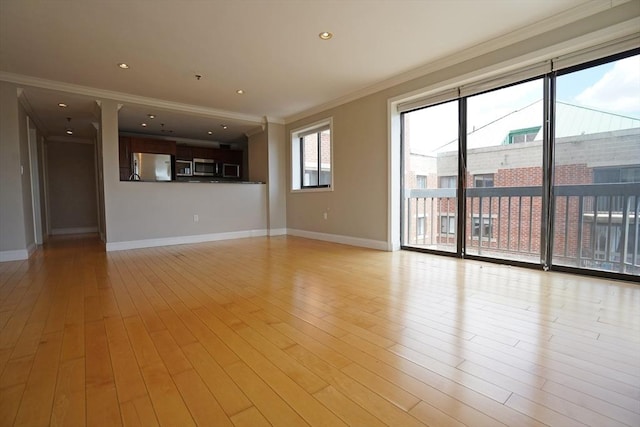 15 N Beacon St Unit 1006, Boston, MA 02134 - unfurnished living room with crown molding, baseboards, and light wood-style flooring