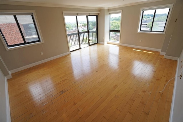 15 N Beacon St Unit 1006, Boston, MA 02134 - empty room with crown molding, baseboards, and light wood-type flooring
