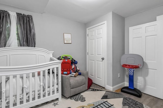 631 Chestnut St, Athol, MA 01331 - bedroom featuring a crib and wood finished floors