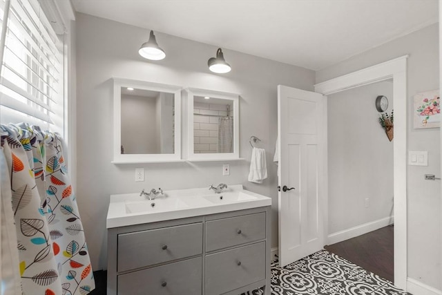 120 Fulton St, Lowell, MA 01850 - full bath with double vanity, baseboards, and wood finished floors
