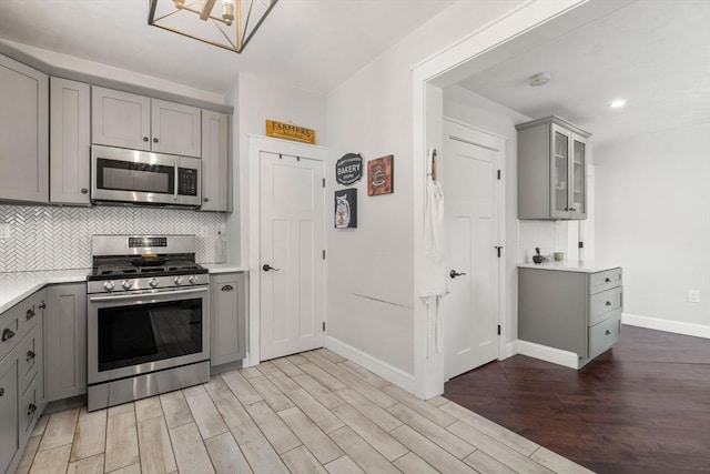 120 Fulton St, Lowell, MA 01850 - kitchen featuring gray cabinetry, stainless steel appliances, baseboards, tasteful backsplash, and recessed lighting