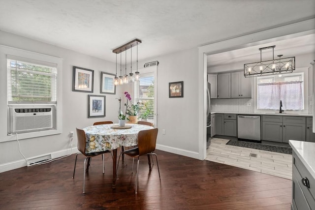 120 Fulton St, Lowell, MA 01850 - dining room with wood finished floors, a chandelier, baseboards, and cooling unit