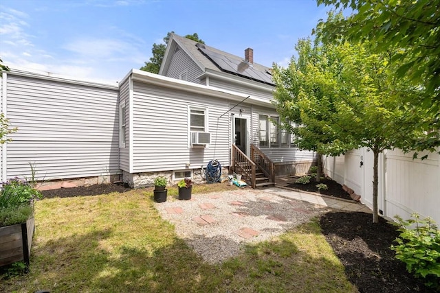 120 Fulton St, Lowell, MA 01850 - rear view of house with entry steps, roof mounted solar panels, and cooling unit