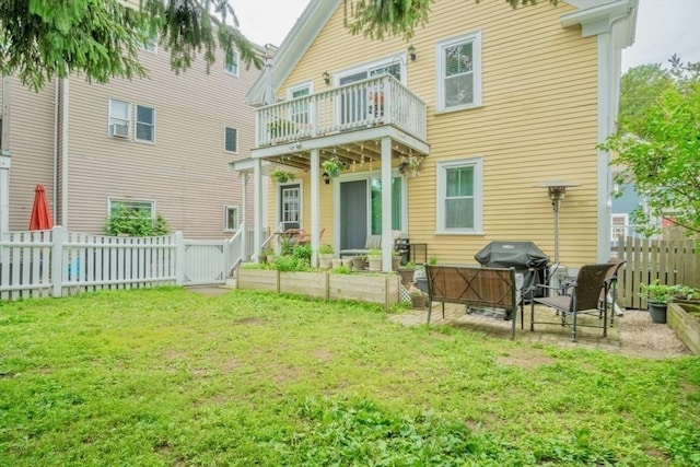 29 Carlton St Unit 2, Salem, MA 01970 - back of property with a balcony, a fenced backyard, a patio, and a garden