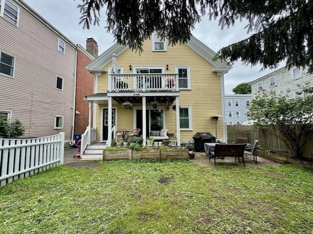 29 Carlton St Unit 2, Salem, MA 01970 - rear view of house featuring a fenced backyard, a balcony, an outdoor living space, and a patio area