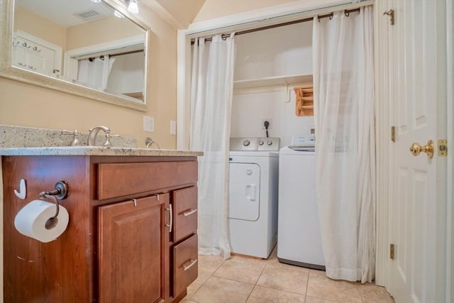 29 Carlton St Unit 2, Salem, MA 01970 - bathroom featuring separate washer and dryer, tile patterned flooring, and vanity