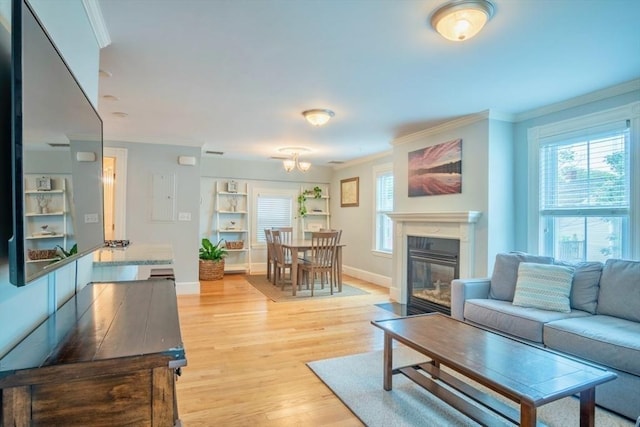 29 Carlton St Unit 2, Salem, MA 01970 - living room featuring ornamental molding, light wood-style flooring, and a fireplace with flush hearth