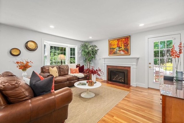 21 Studio Rd, Newton, MA 02466 - living area featuring plenty of natural light, light wood finished floors, a brick fireplace, recessed lighting, and baseboards