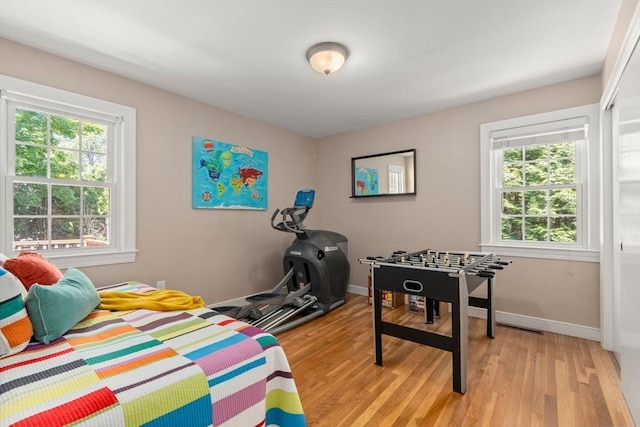 21 Studio Rd, Newton, MA 02466 - bedroom featuring multiple windows, light wood-style flooring, and baseboards