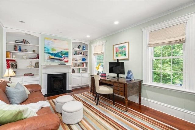 21 Studio Rd, Newton, MA 02466 - office featuring wood finished floors, a fireplace with flush hearth, baseboards, ornamental molding, and built in shelves