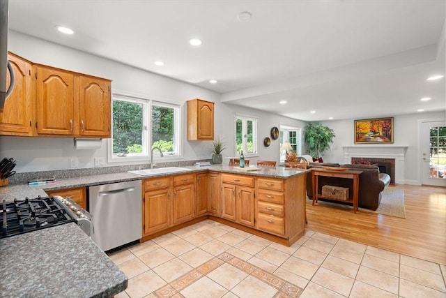 21 Studio Rd, Newton, MA 02466 - kitchen with dishwasher, a sink, light tile patterned floors, a peninsula, and range with gas cooktop